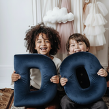 Children with Dark Blue DO Letters